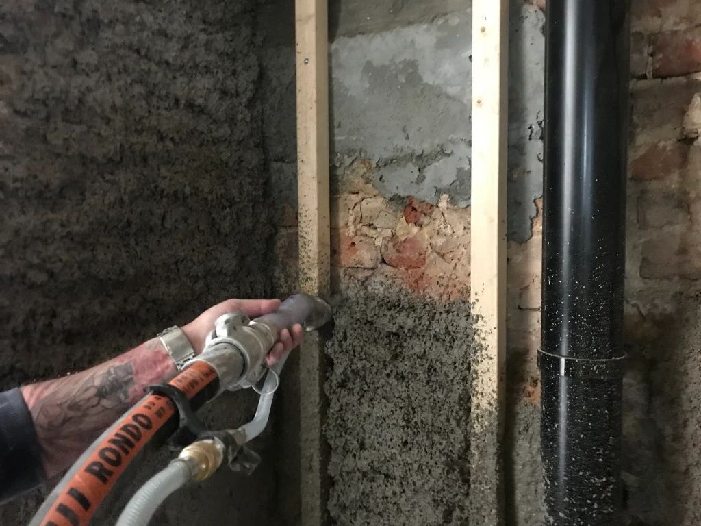 Diathonite being sprayed onto a solid wall