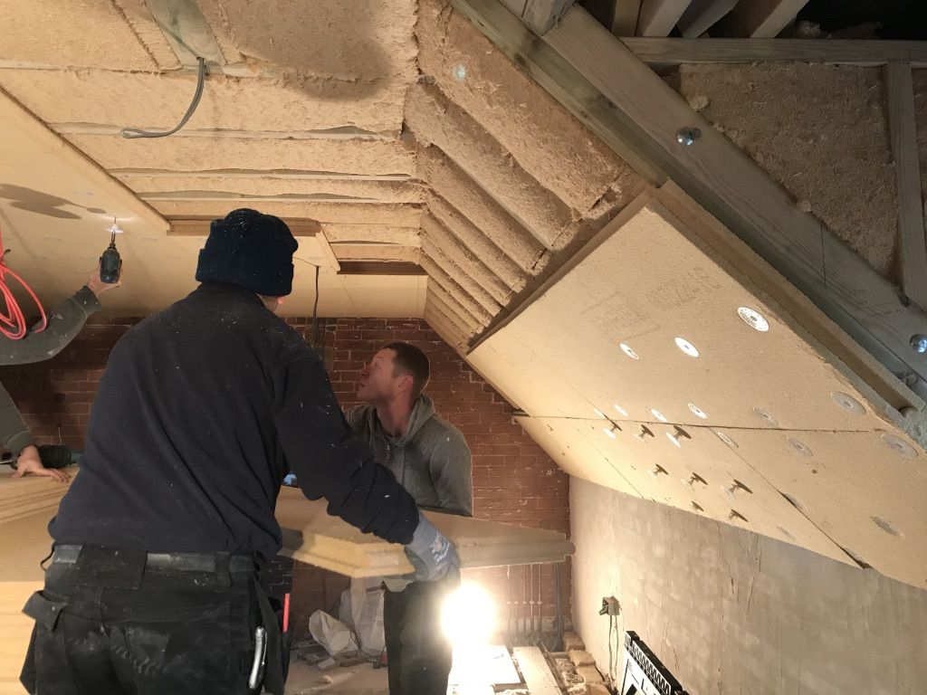 Insulation going in under a roof