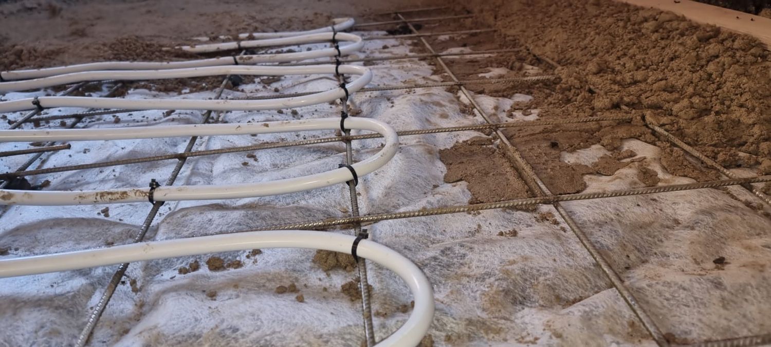Underfloor heating pipes neatly tied to stainless steel mesh