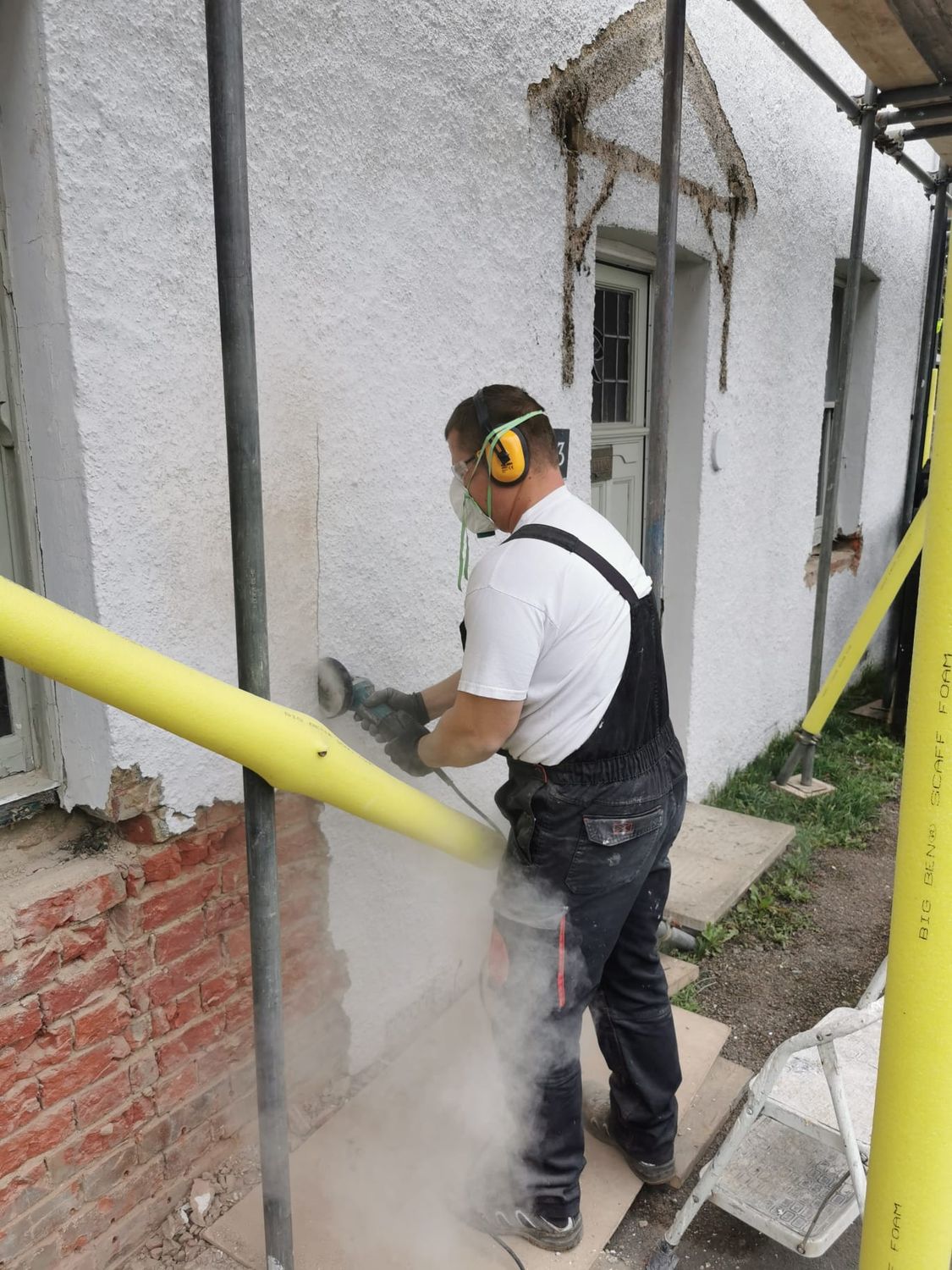 Preparation- cement render being taken back to bare brickwork