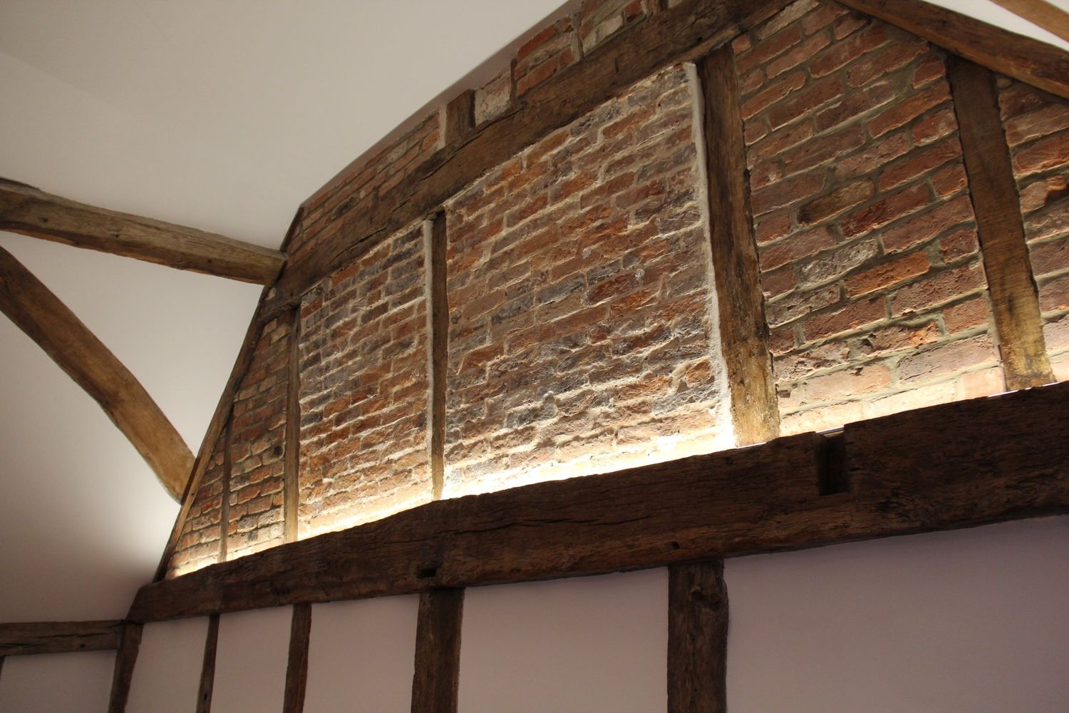 Oak framed gable wall with lime plastered panels