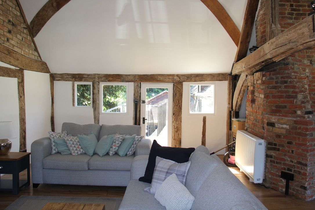Internal room of 16th century oak framed listed building, with insulation and lime plaster completed