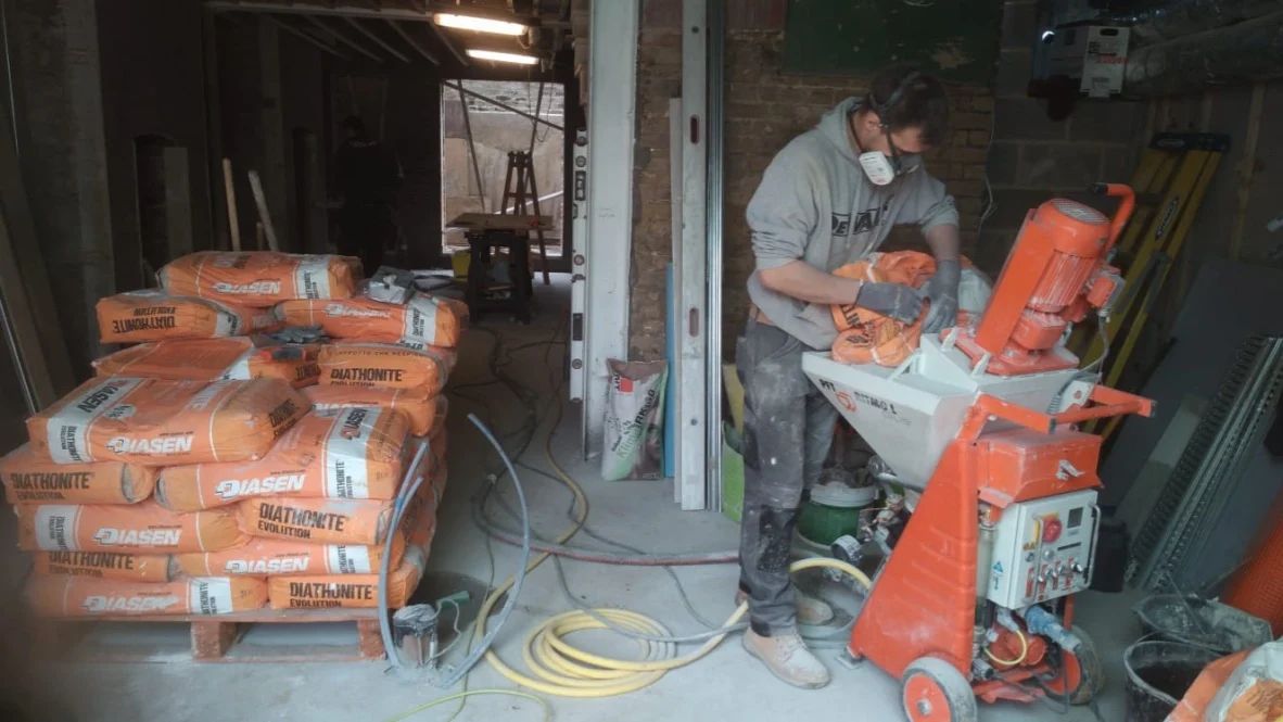 Diathonite Evolution lime-cork-clay insulating mixture being fed to spray pump