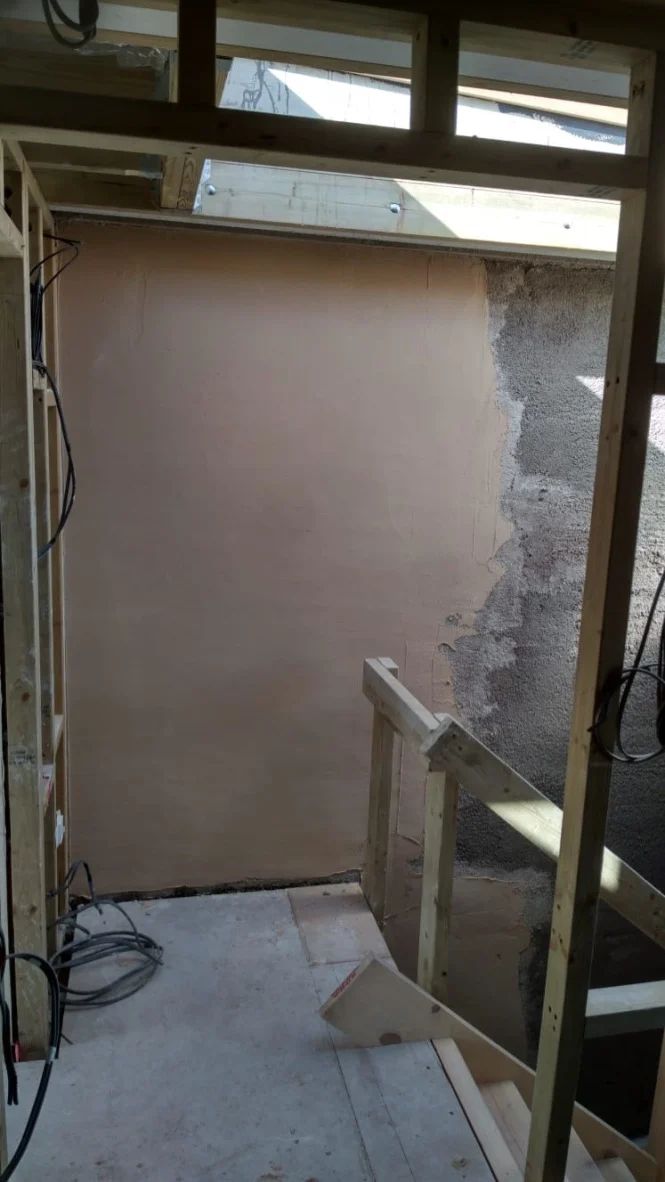 Lime smoothing coat goes onto insulated walls