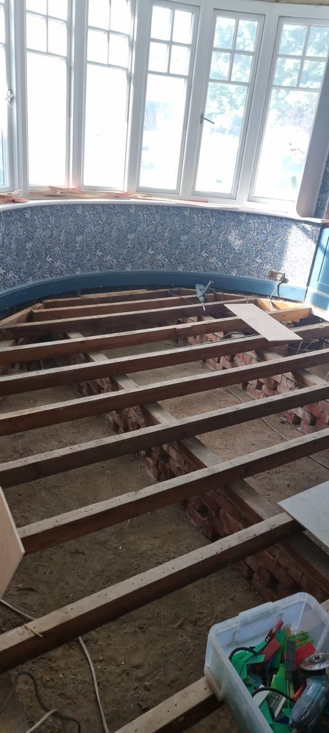 Suspended floor insulation - floorboard removed, structure is ready for insulation and membrane