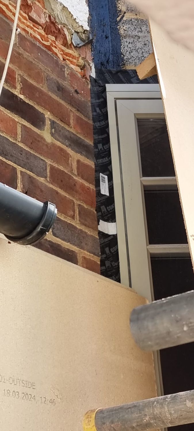 Preparation for external wall insulation - airtightness detail - pro clima contega solido exo tape installed behind wood fibre insulation to window frame and fabric junction