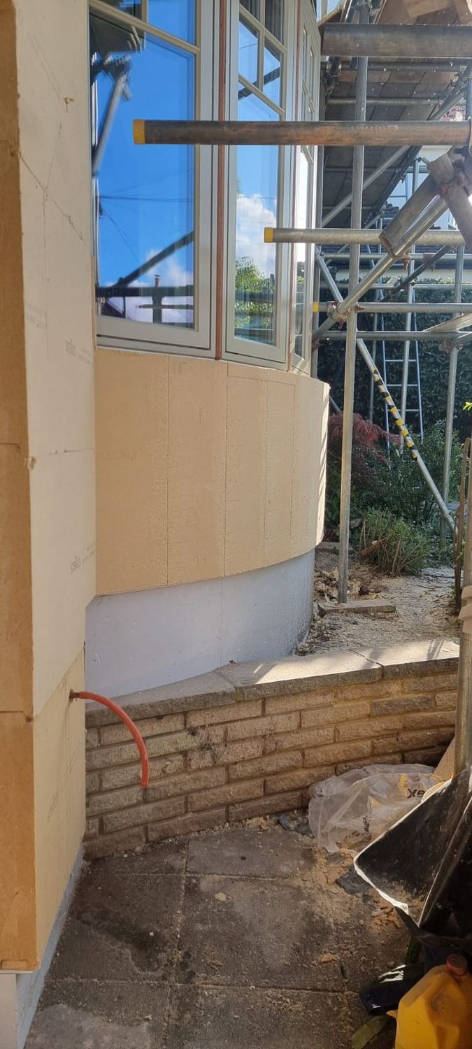 Installation of Steico wood fibre boards and plinth insulation on bay wall