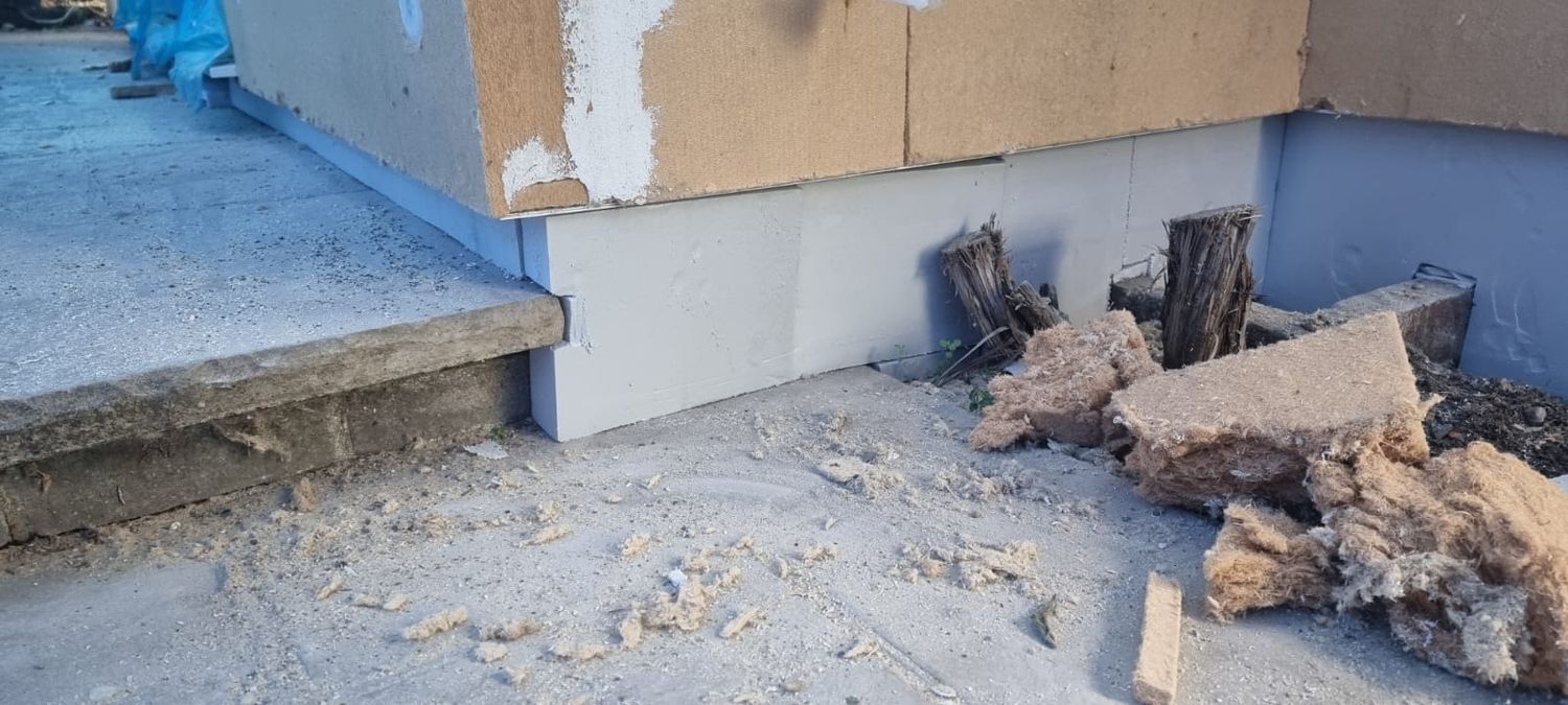 Installation of plinth insulation boards below wood fibre boards, below dpc level