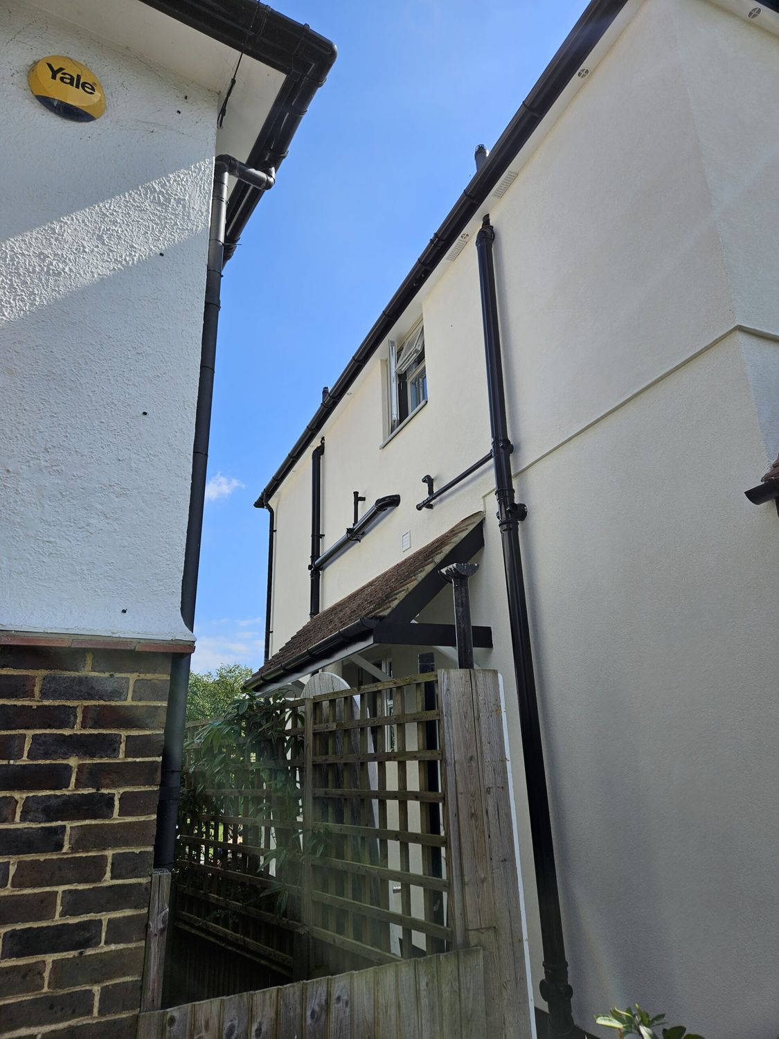 Detailing - external wall insulation with downpipes and porch roof refitted
