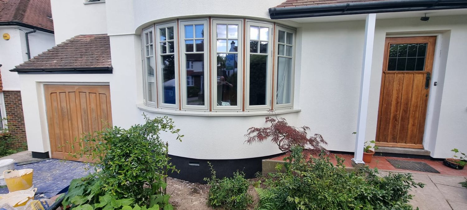 External wall insulation with wood fibre boards, silicone render finish and black mosaic plinth insulation - front