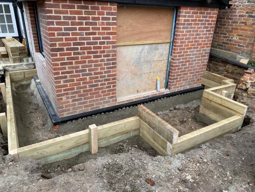 New surface drain and paving installed around new extension