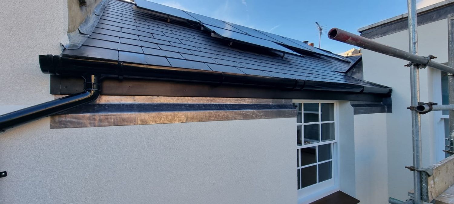 Lead flashing installed at top of wood fibre insulation system and rainwater gutters re-fitted