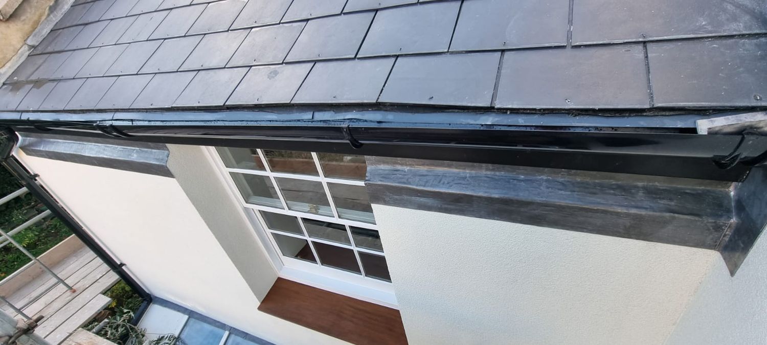 Lead flashing installed over chamfered wood fibre external wall insulation in Brixton, London