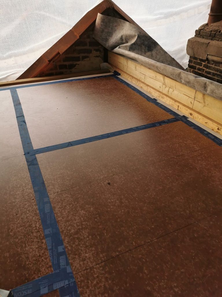 Installing Finsa airtight vapour barrier racking board for new timber frame flat roof