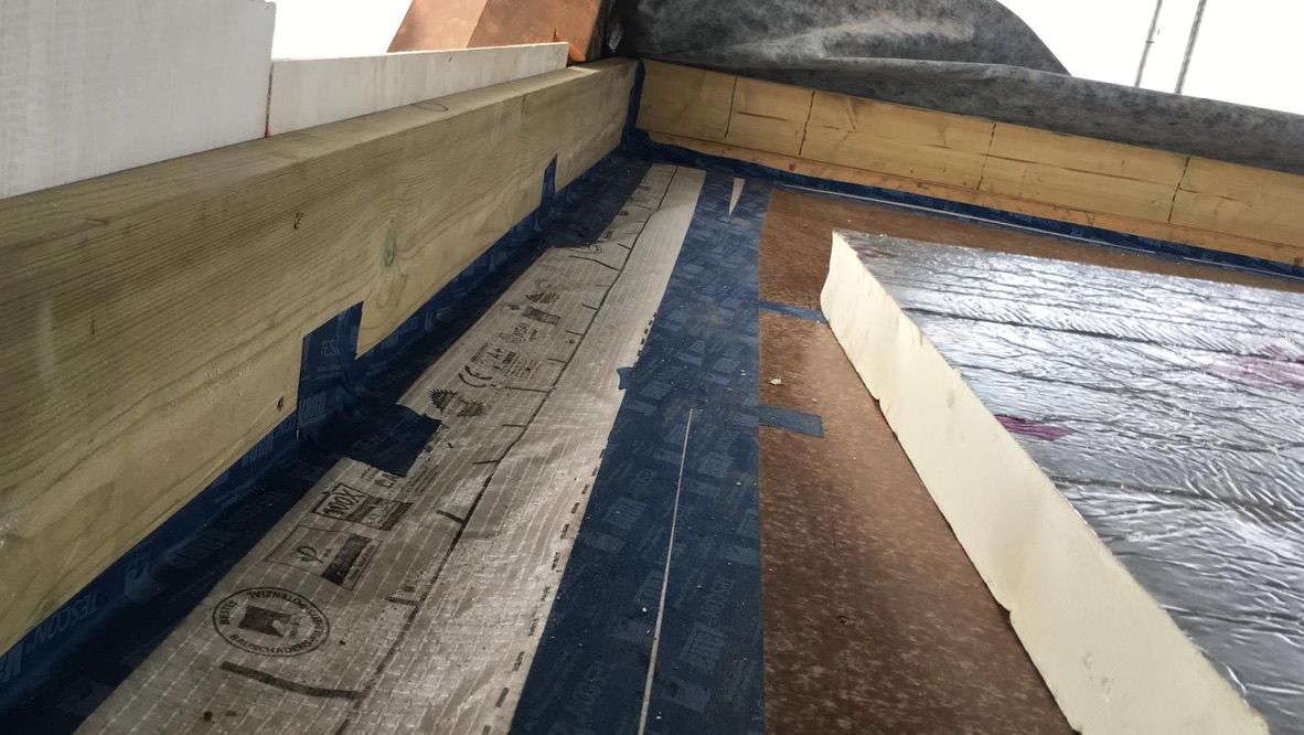 Airtight taping around new timber frame flat roof before insulation boards installed