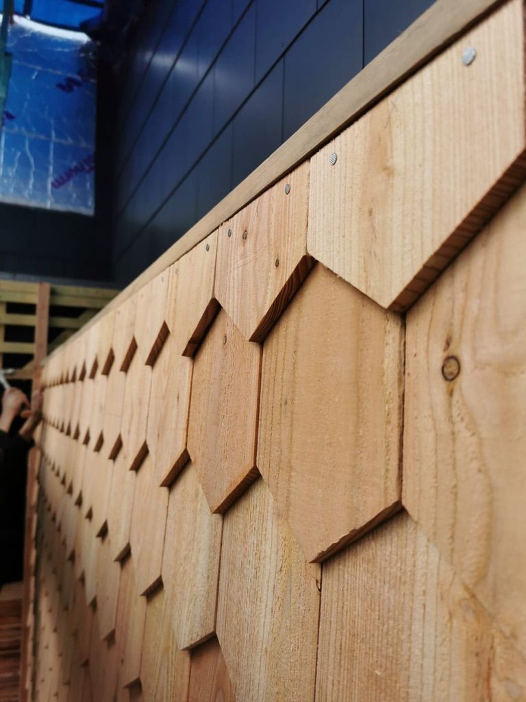 Installation of hexagonal cedar wood shingle cladding