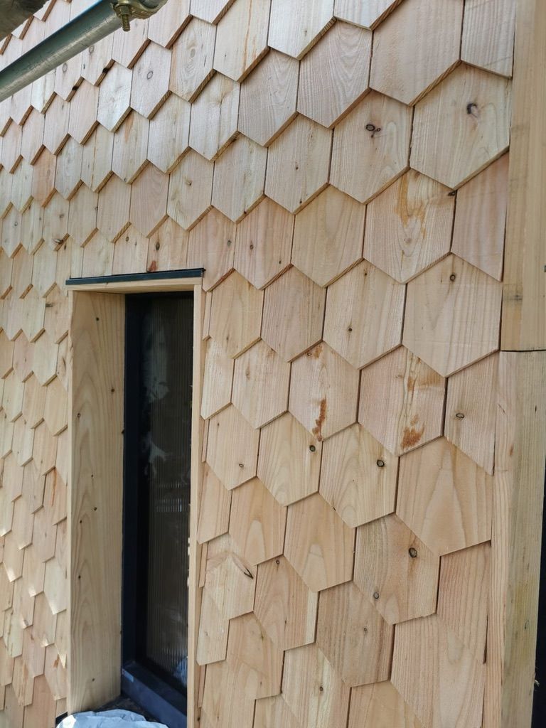 Installation of hexagonal cedar wood shingle cladding