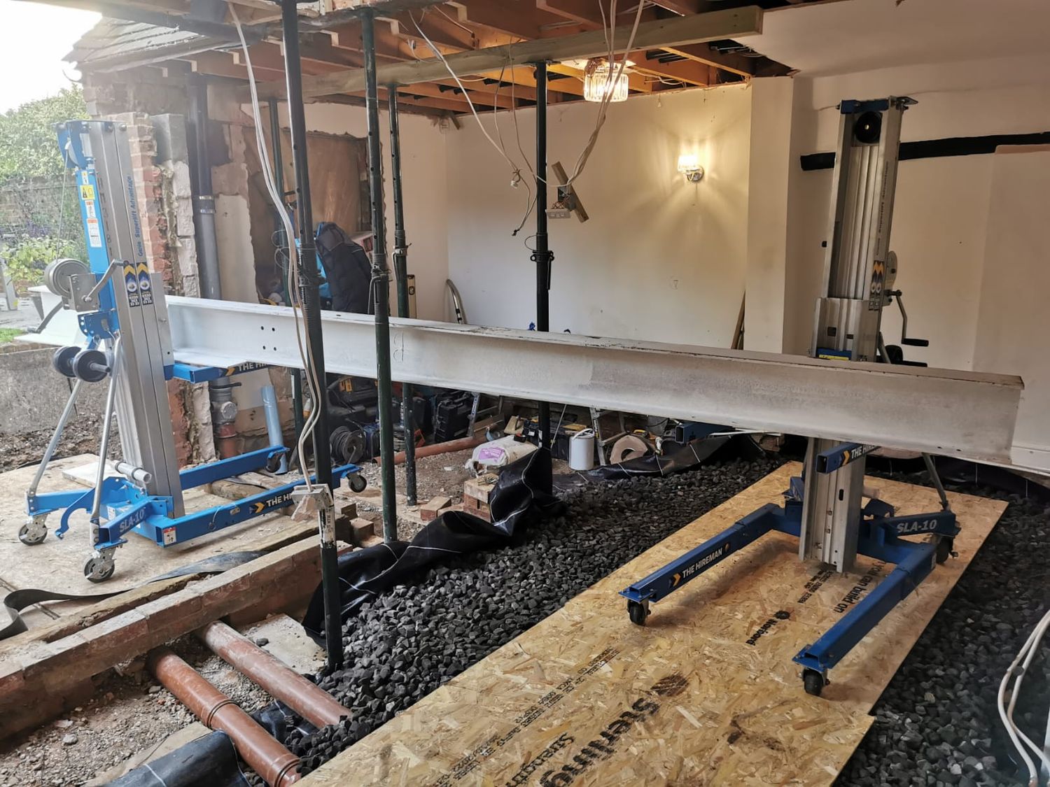 Lifting new structural steel beam to place