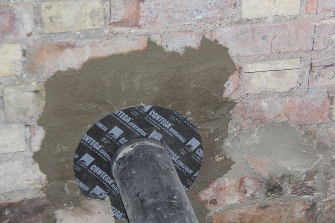 Airtightness works using Pro Clima Roflex Solido Airtight Grommet around drainage outlet in Muswell Hill, London