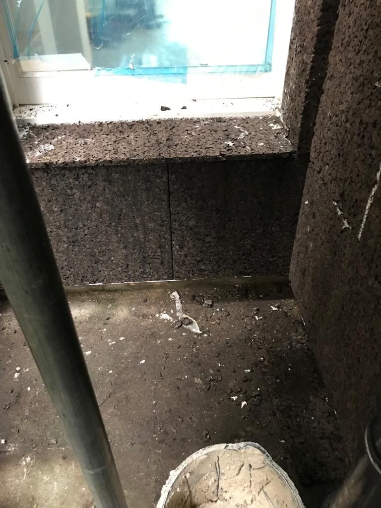 Cork boards installed around window reveals
