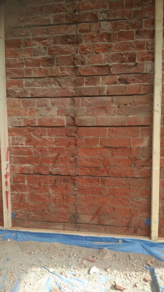 Cement render being taken down