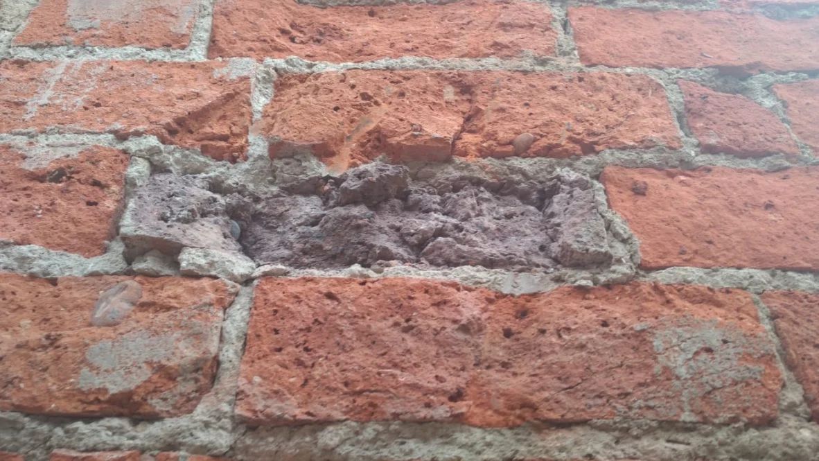 Spalling victorian brickwork due to cement render
