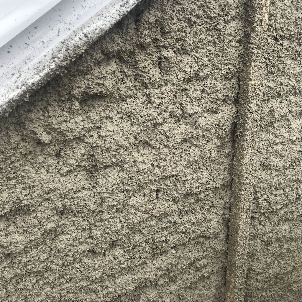 Sprayed first coat of lime cork render