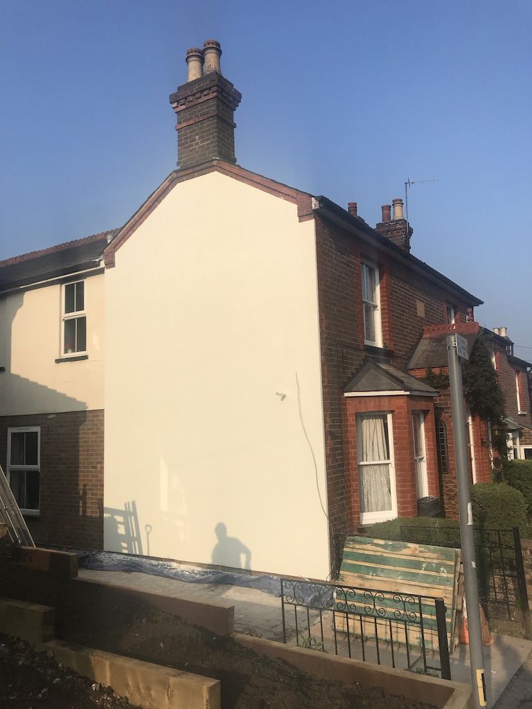 Breathable top coat applied to insulated wall