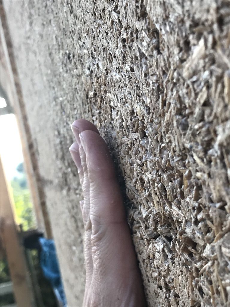 Dried hempcrete wall with visible hemp fibres, hempcrete texture