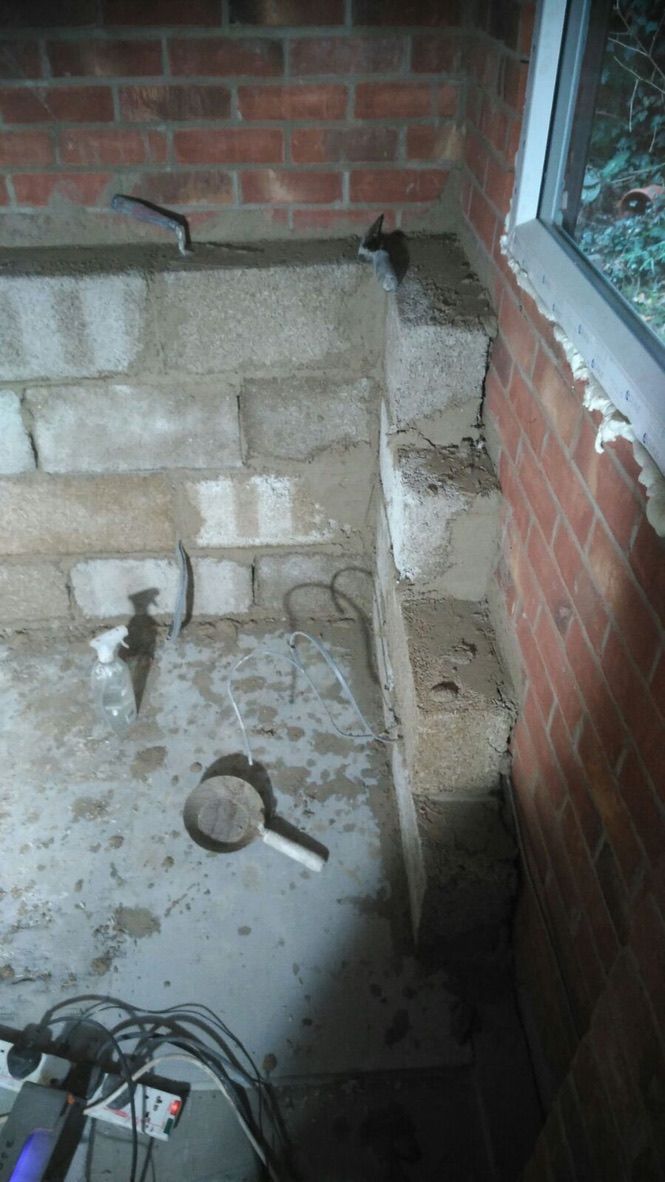 Natural hempcrete blocks being installed internally onto single skin masonry wall