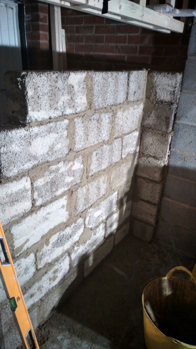 Natural hempcrete blocks being installed internally onto single skin masonry wall