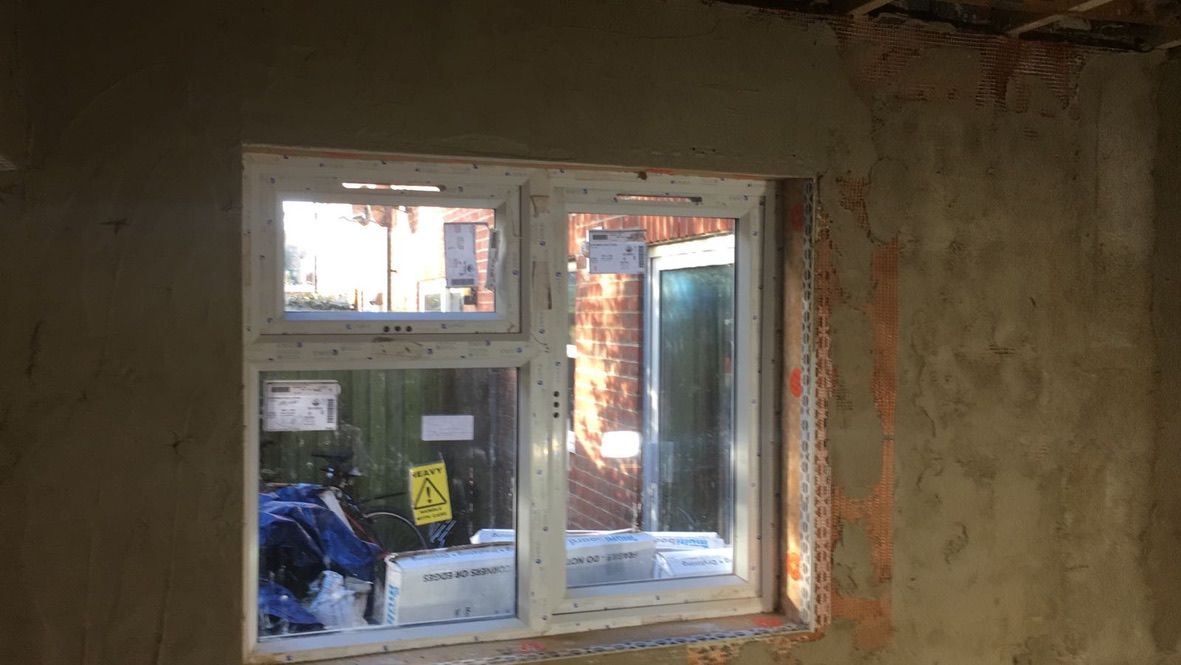 Breathable lime plaster being applied onto hempcrete blocks