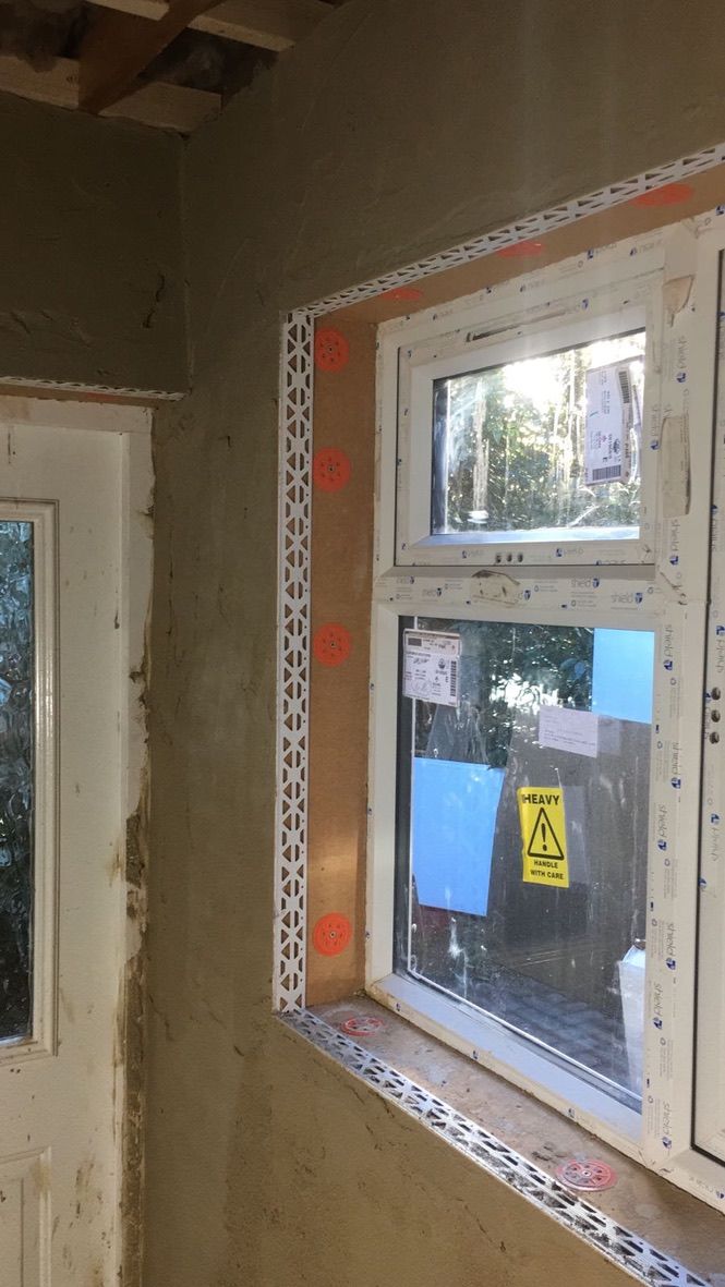 Breathable lime plaster being applied onto hempcrete blocks