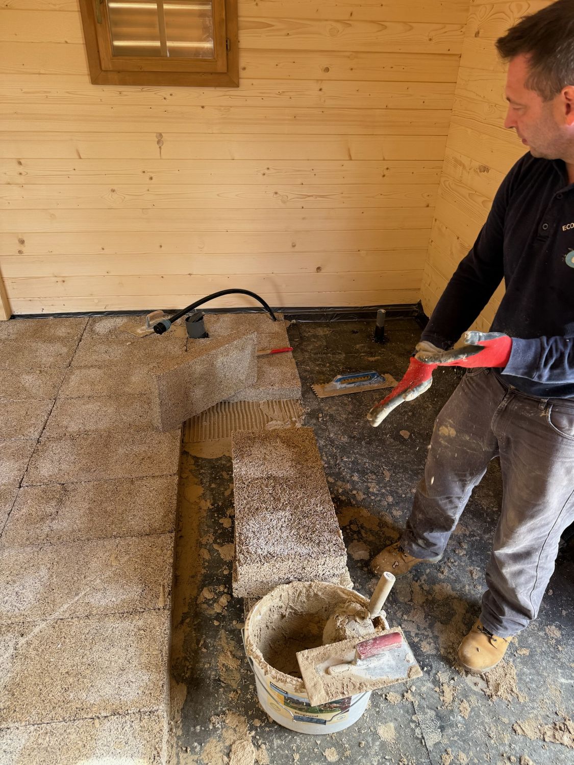 IsoHemp hempcrete blocks being adhered to floor