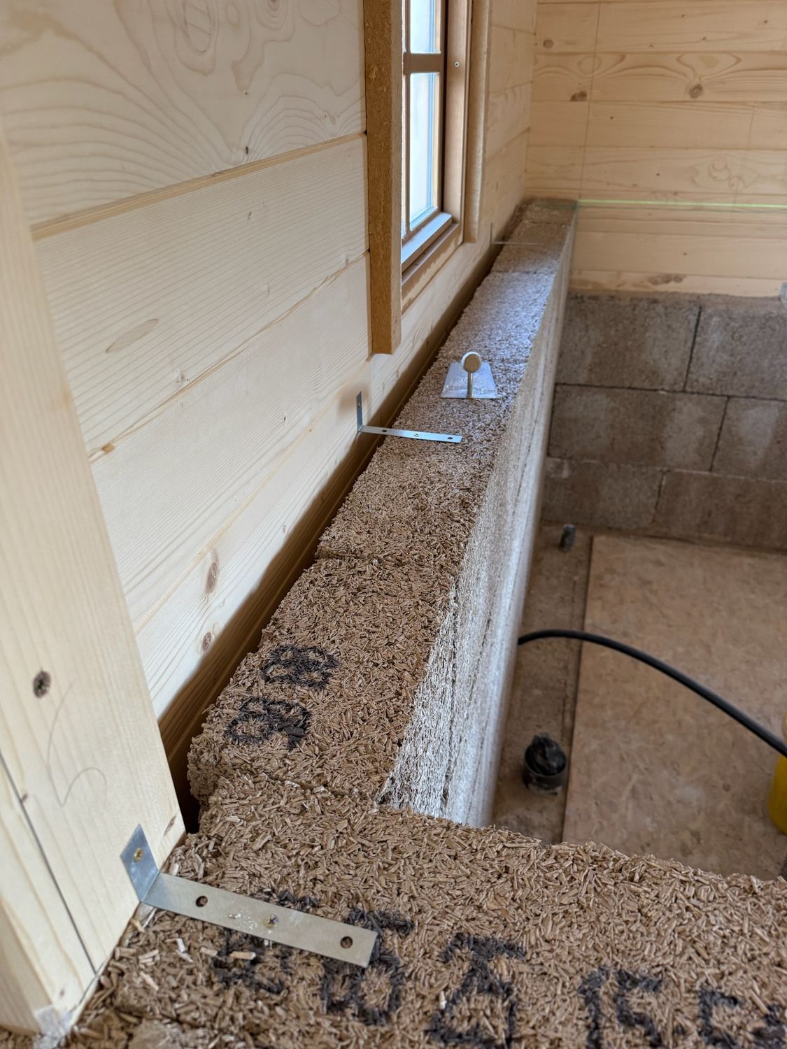 IsoHemp hempcrete blocks installed as internal wall insulation to timber building