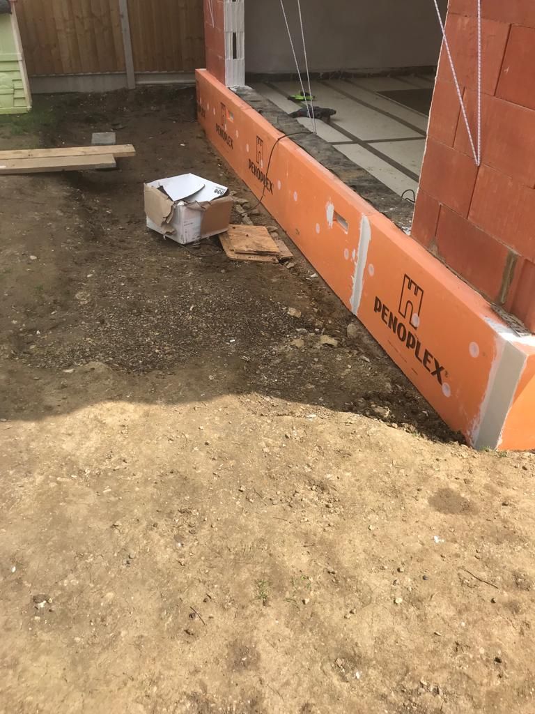 Plinth insulation boards being installed around perimeter of new extension