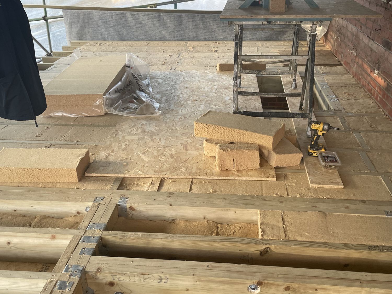 Flexible wood fibre insulation being installed to new roof structure
