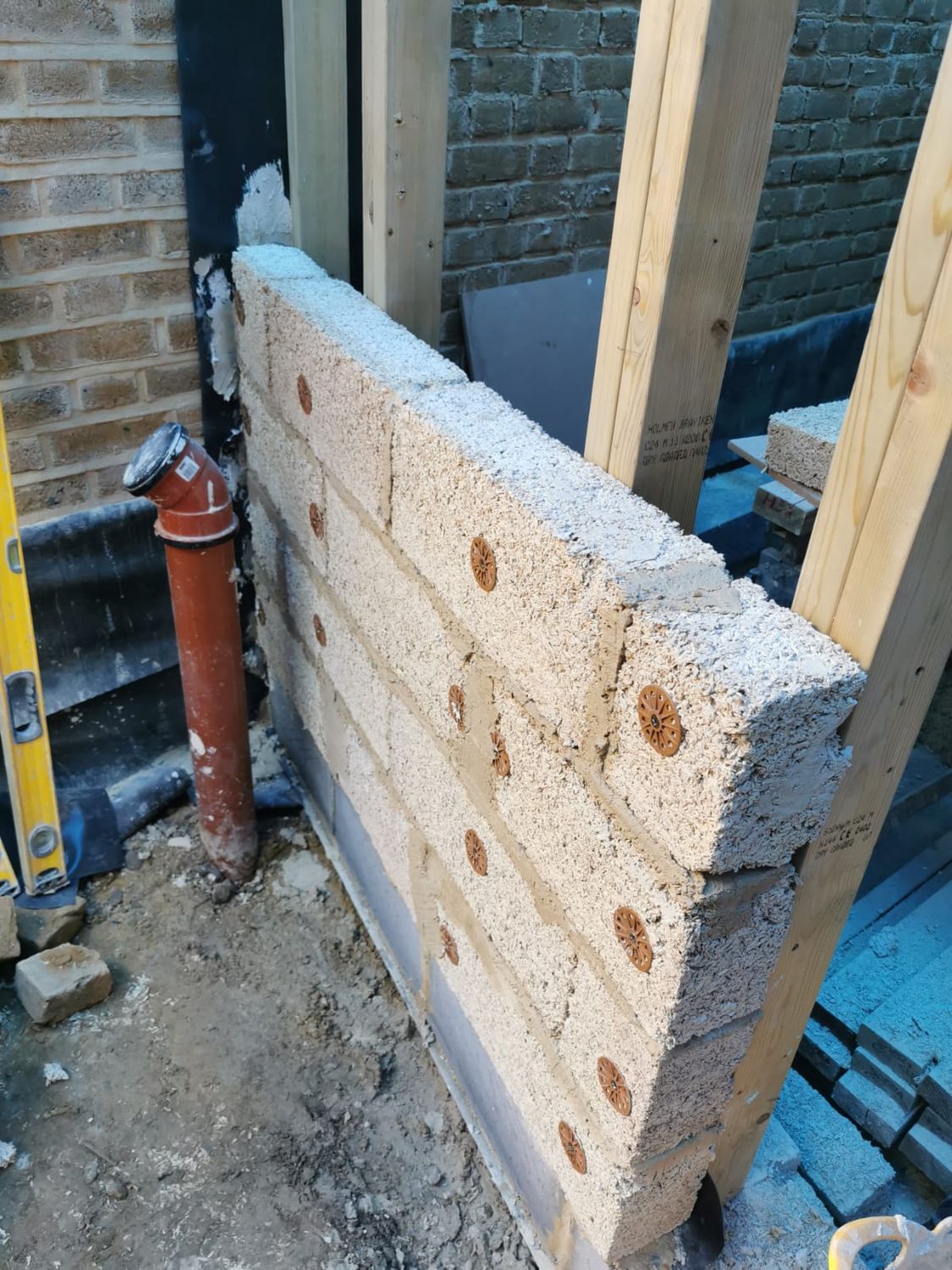 New extension wall being built with hempcrete blocks