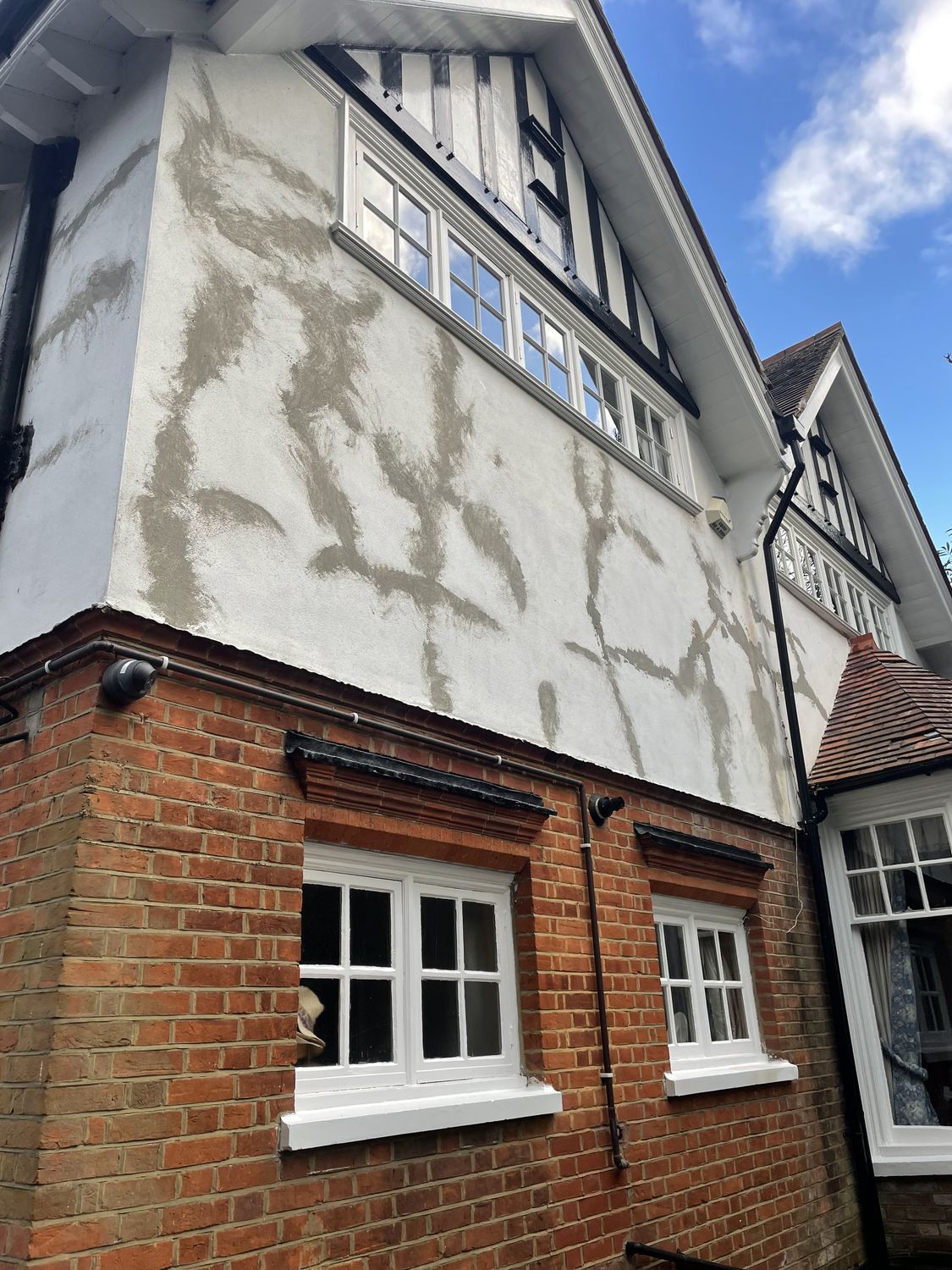Cement render applied cracked and "repaired" on listed building - to be taken off
