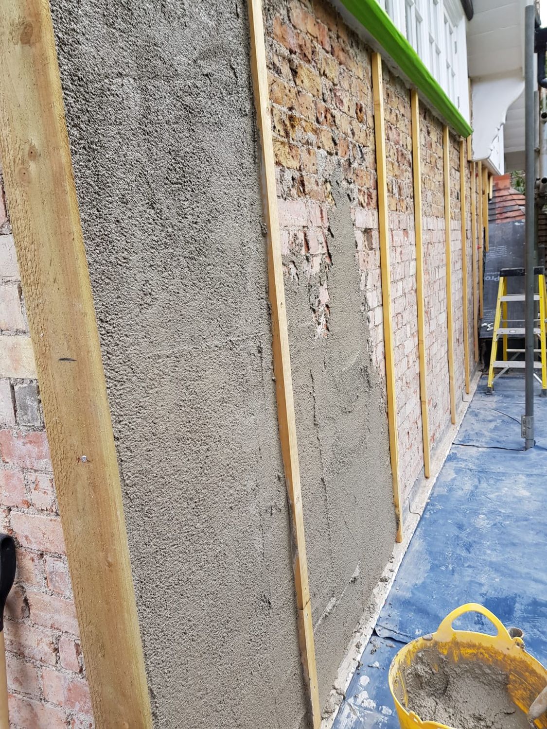 Diathonite Evolution lime-cork-clay insulating render being applied in Harrow, London