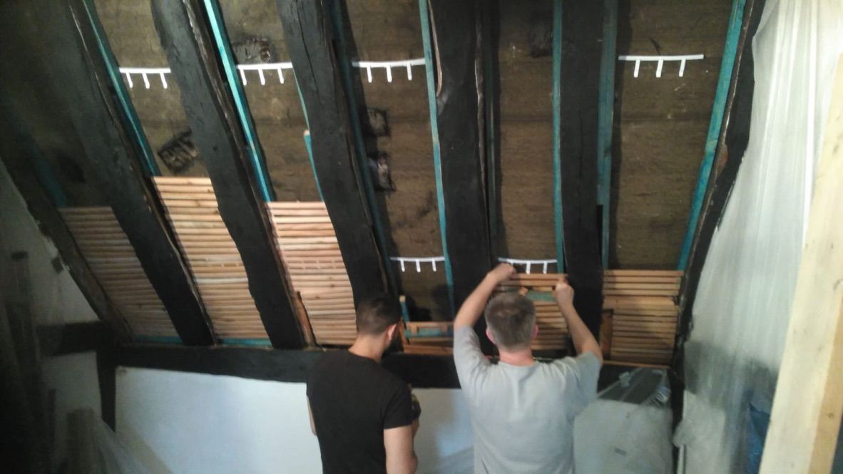 Lath being fitted between rafters